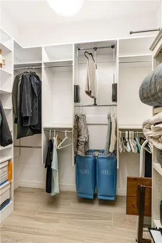 Walk in closet featuring wood finish floors