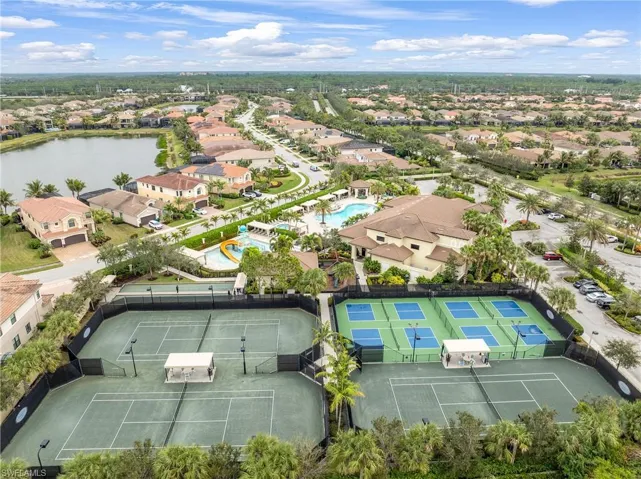Aerial perspective of suburban area with a pool area and a nearby body of water