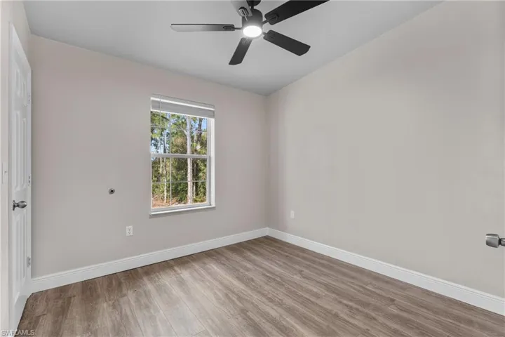 Spare room featuring light wood finished floors and a ceiling fan