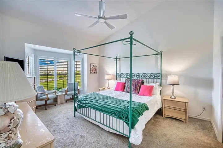 Bedroom featuring carpet floors, high vaulted ceiling, and a ceiling fan