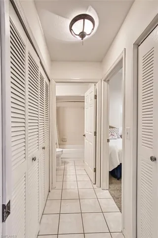 Hall featuring light tile patterned floors