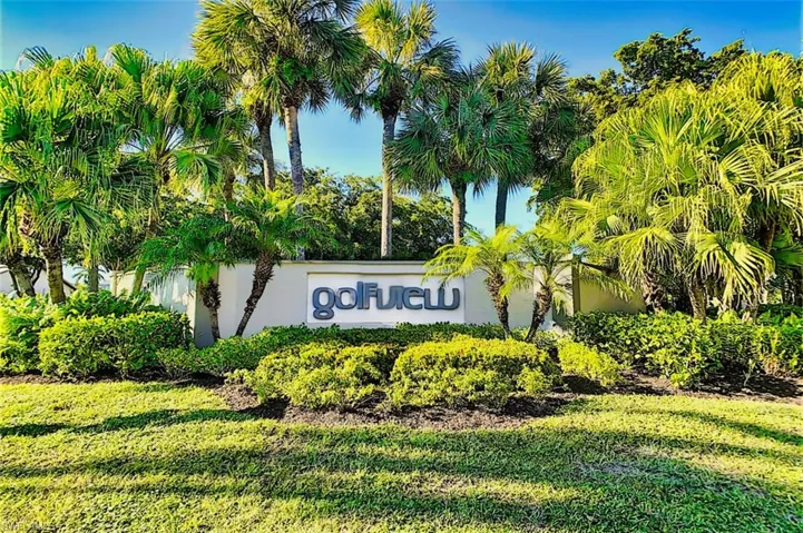 Community / neighborhood sign featuring a lawn