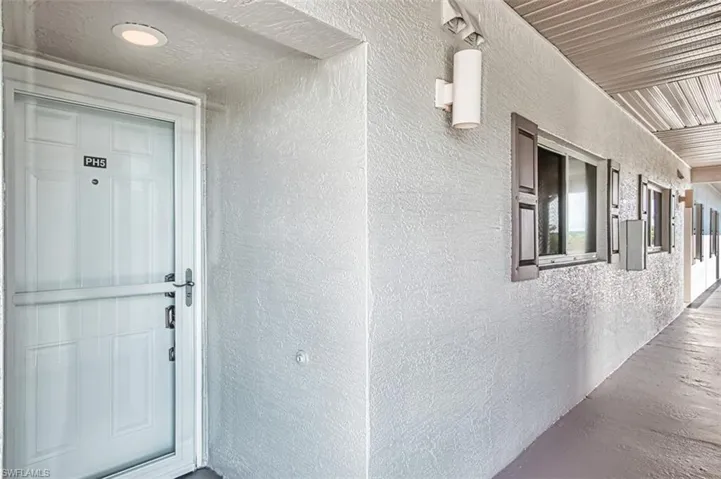 View of exterior entry featuring stucco siding