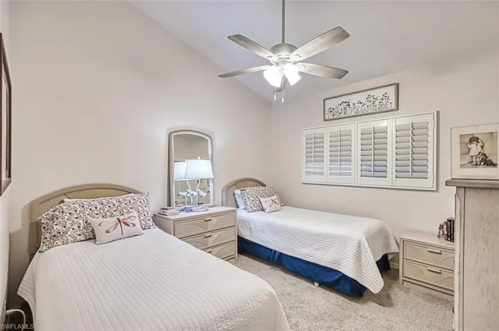 Bedroom featuring lofted ceiling, carpet, and ceiling fan