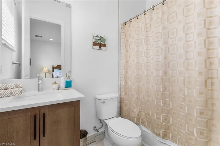 Full ensuite guest bathroom featuring vanity and tub / shower combination