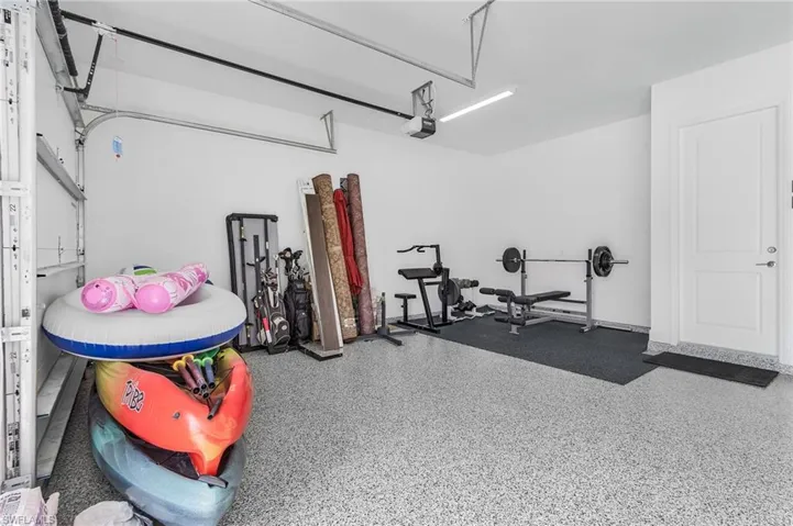 Luxury Garage with Epoxy Floor and custom shelving and storage in your 3 car garage