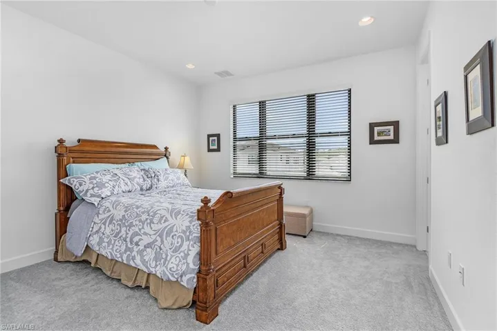 Guest Bedroom with carpet floors, ensuite full bath, walk in closet and recessed lighting