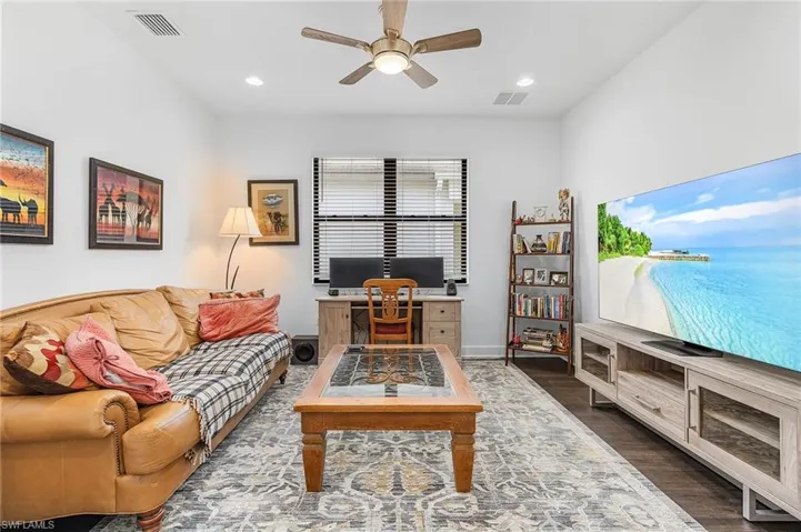 Den or study featuring dark wood-style flooring, ceiling fan, and recessed lighting