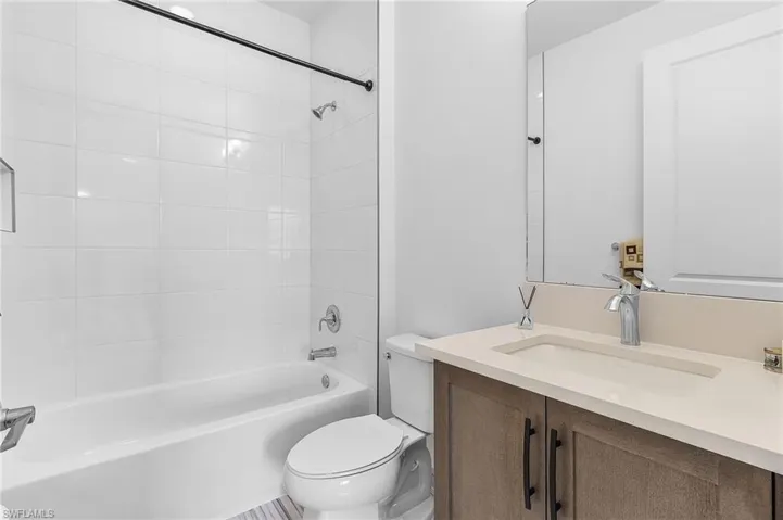 Full ensuite guest bathroom featuring vanity and tub / shower combination