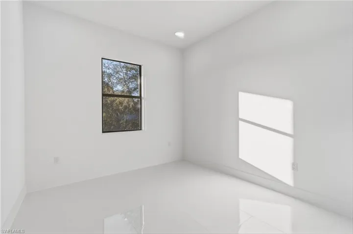Tiled empty room featuring baseboards and recessed lighting
