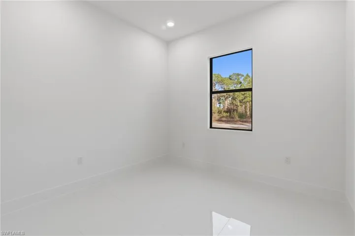 Unfurnished room with recessed lighting and tile patterned floors