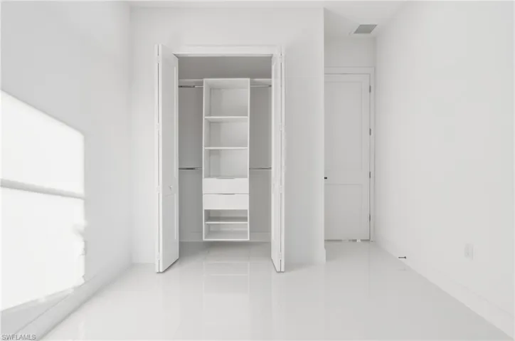 Unfurnished bedroom featuring a closet and light tile patterned flooring