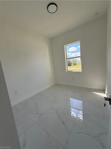 Empty room with light marble finish floors and baseboards