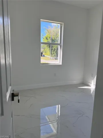 Empty room featuring light marble finish flooring