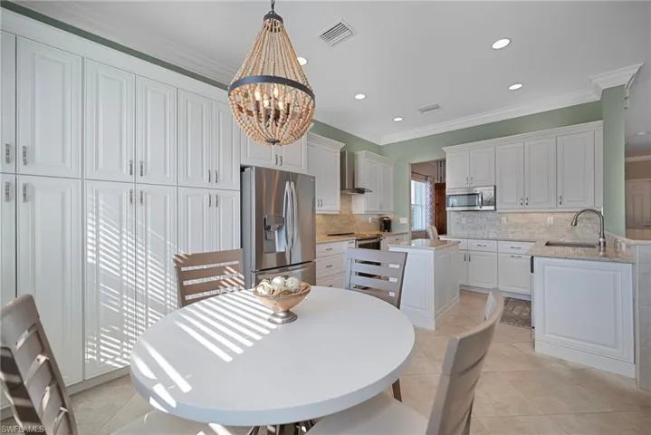 THIS LIGHT AND BRIGHT KITCHEN HAS LOTS OF CABINET SPACE.