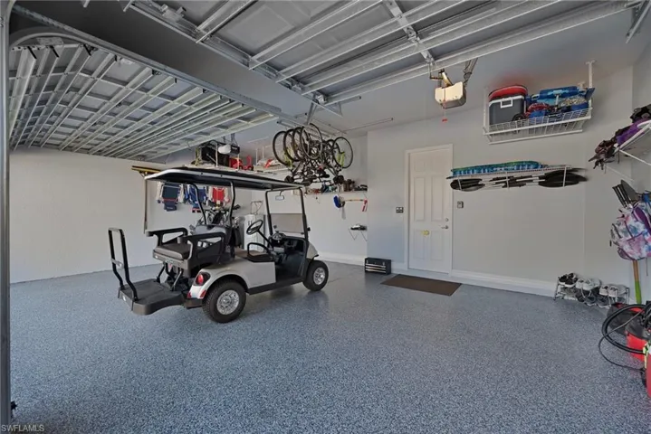 THREE CAR GARAGE WITH AN EPOXIED FLOOR.