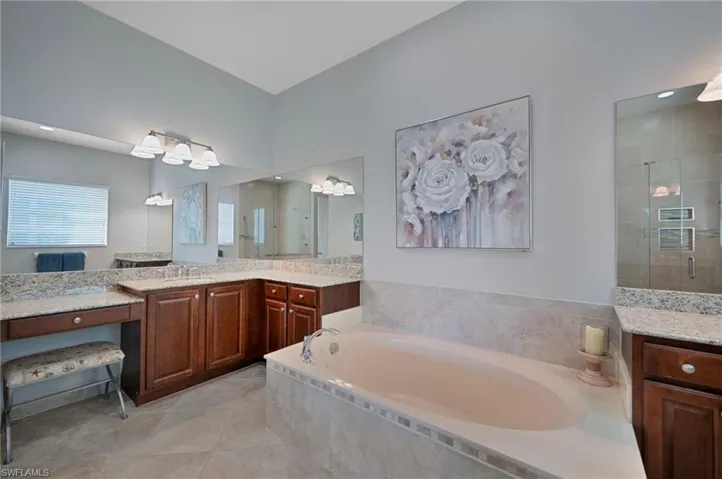 TWO SINKS AND VANITY AREA WITH LOTS OF CABINETS.