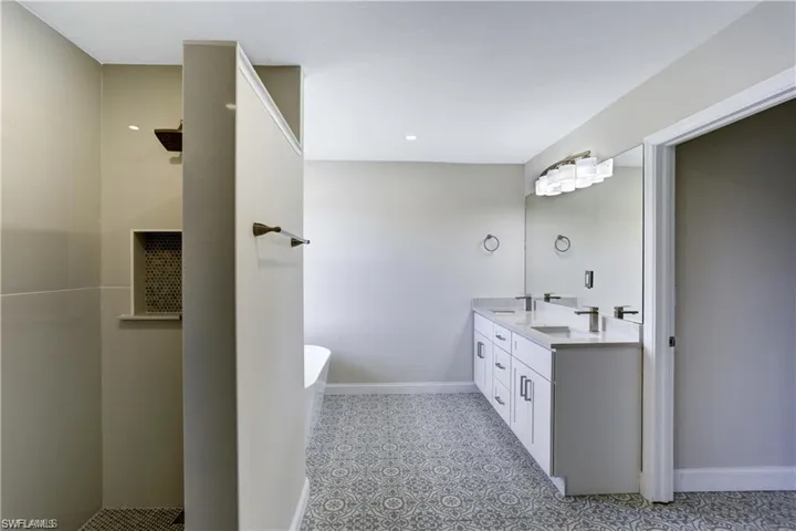 Beautiful bathroom with custom tile, double sinks, walk in shower