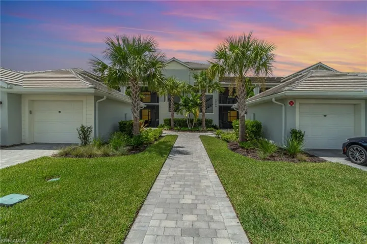Single story home featuring a garage and a yard