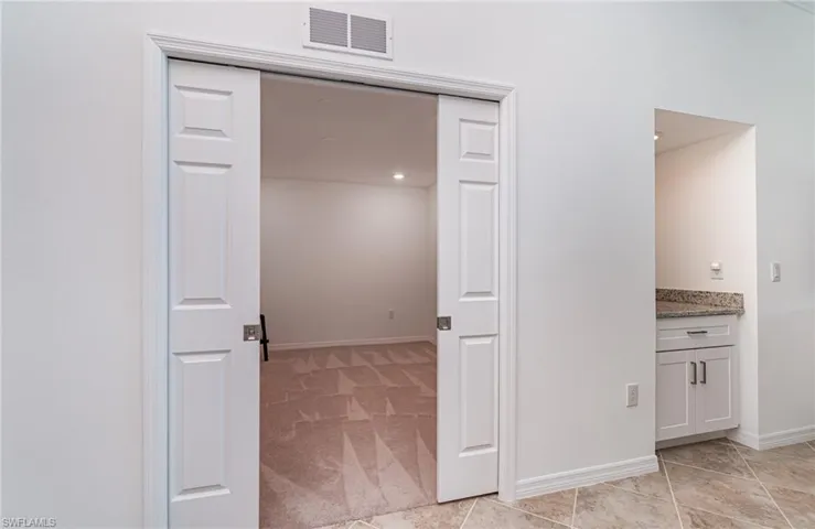 Corridor with light colored carpet