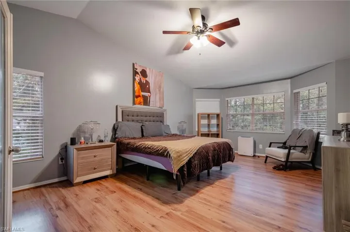 Bedroom featuring lofted ceiling, ceiling fan, and light hardwood / wood-style flooring