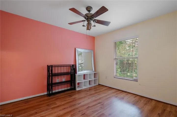 Empty room with light hardwood / wood-style floors and ceiling fan