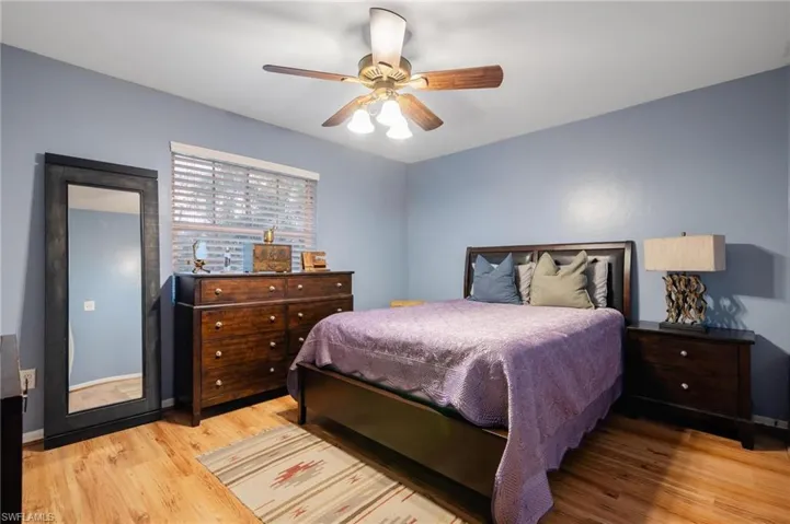 Bedroom featuring light hardwood / wood-style floors and ceiling fan