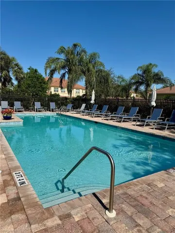 Pool featuring a patio and fence