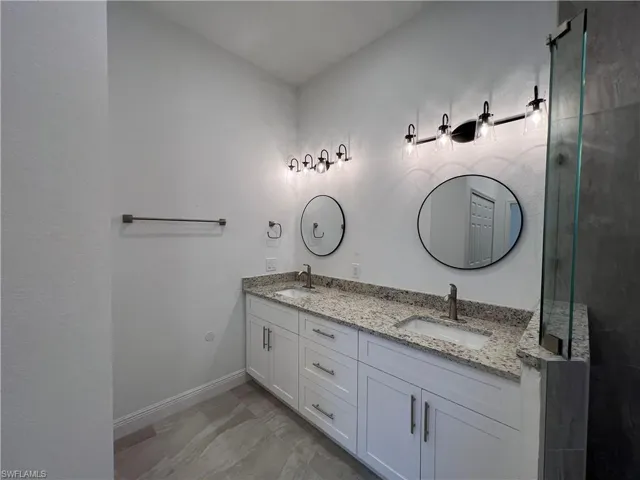 Bathroom featuring tile patterned flooring and vanity