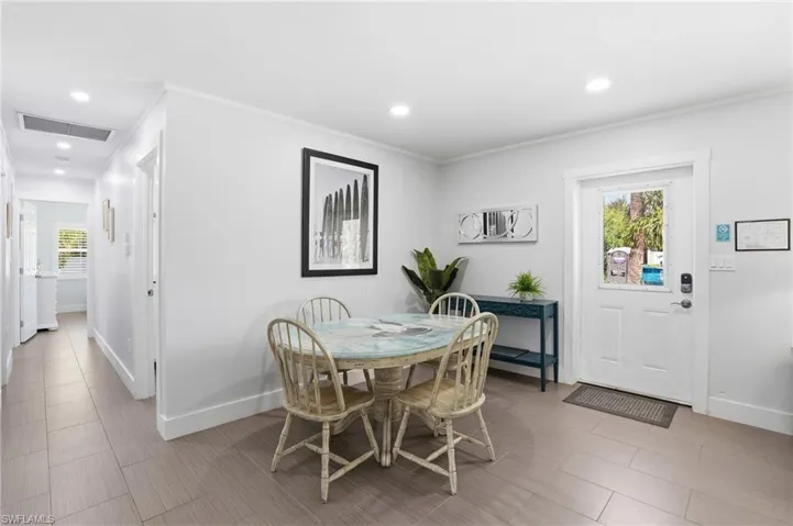 Light gray wood-finish flooring extends throughout this interior space - Virtually Edited Image