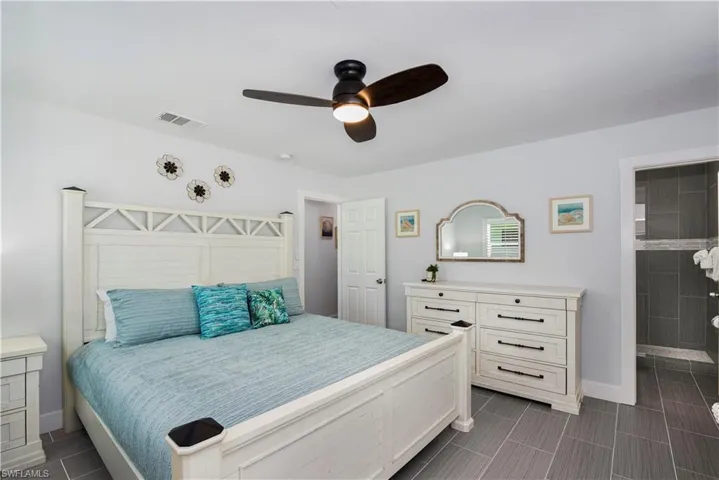 Bedroom with ceiling fan and baseboards - Virtually Edited Image
