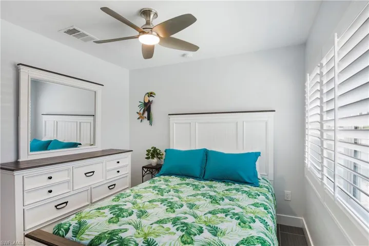 Bedroom with a ceiling fan and baseboards - Virtually Edited Image