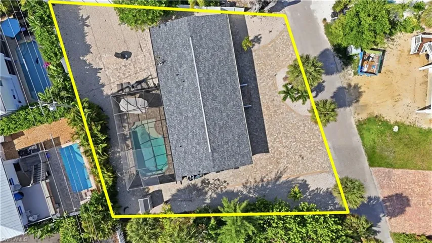 Aerial view showcasing a rectangular property with extensive hardscaping
