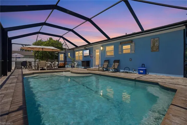 Screen-enclosed swimming pool with a paved deck - Virtually Edited Image