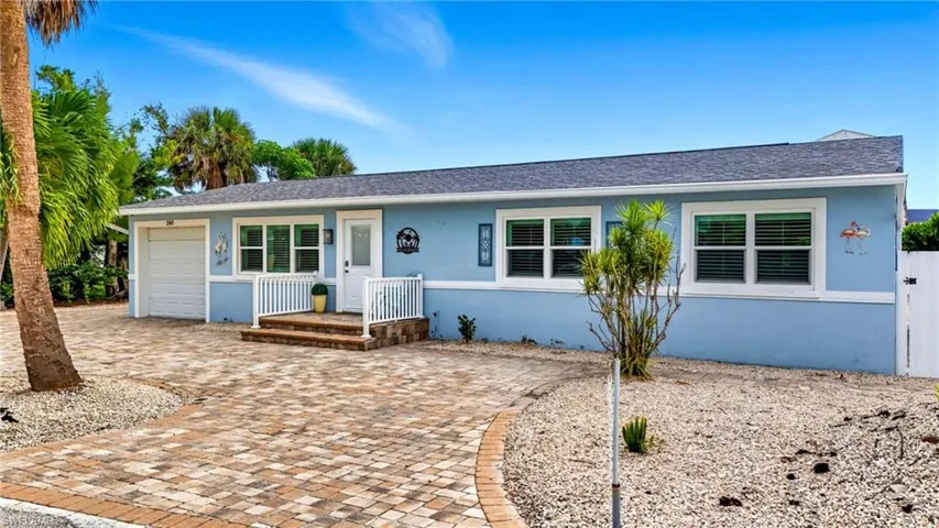 Ranch-style home with roof with shingles, stucco siding, an attached garage, and driveway - Virtually Edited Image