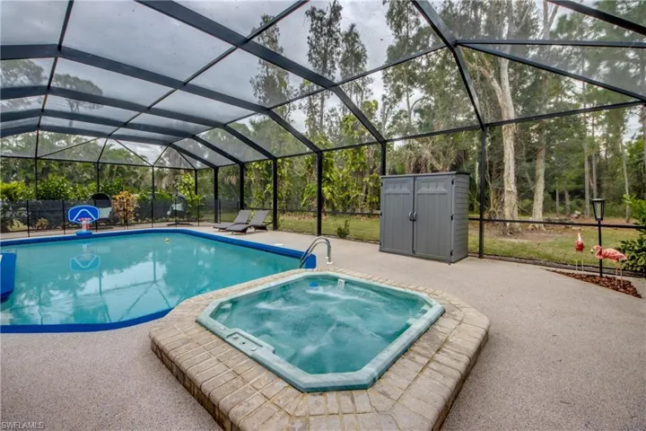 Swimming pool with a lanai, an in-ground hot tub, and a sunroom