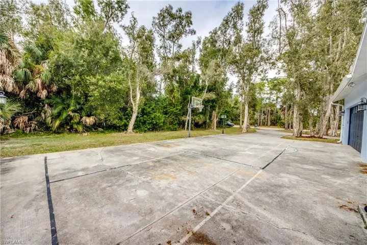 View of patio / terrace with community basketball court and view of scattered trees