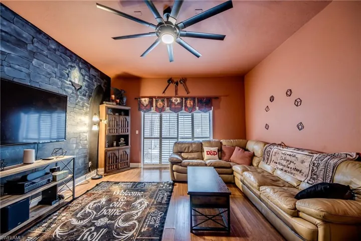 Living room featuring wood finished floors and ceiling fan
