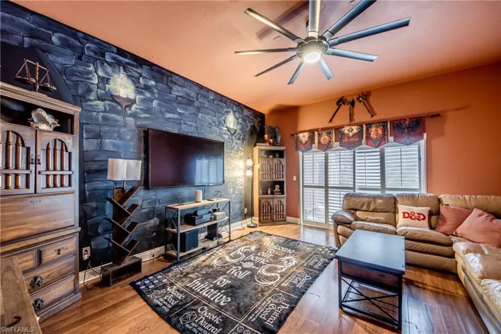 Living area featuring a ceiling fan and wood finished floors