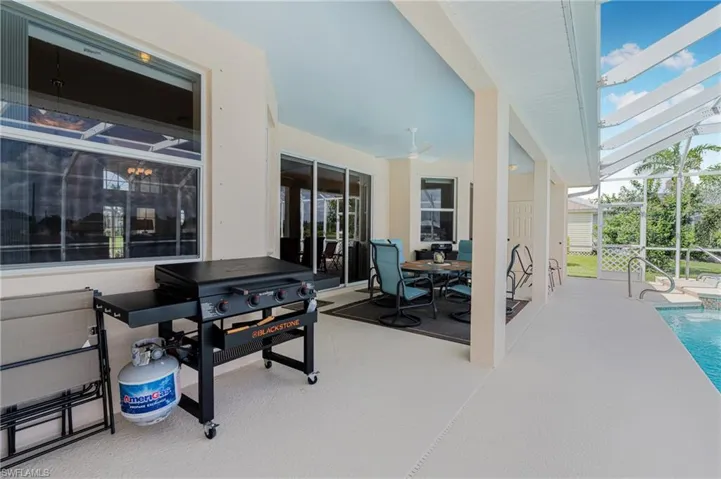 View of patio / terrace with ceiling fan and a lanai