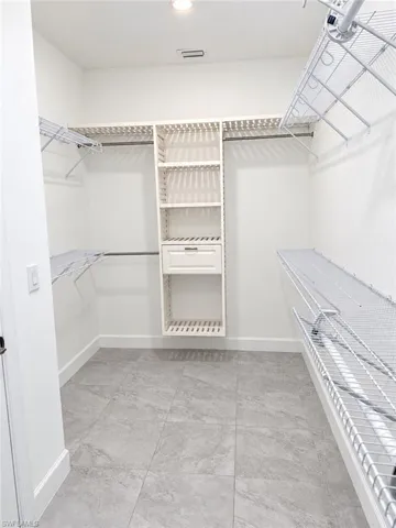 Built-in closet system with shelving, integrated drawer, and multiple hanging rods