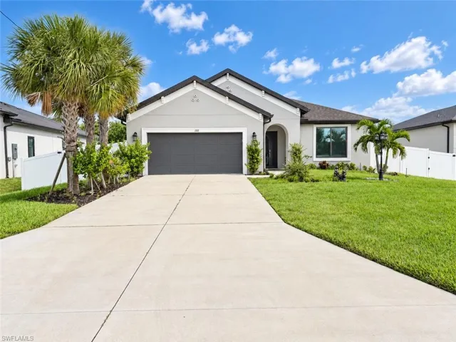 Contemporary stucco exterior with a dark shingle roof