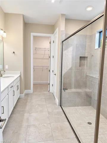 Dual vanity with white cabinetry and integrated sinks