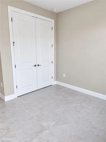 Neutral wall color, white trim, and light-toned tile flooring