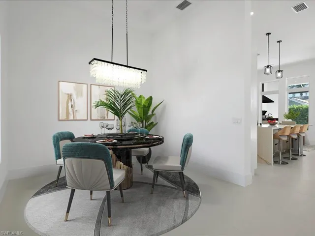 Dining space featuring baseboards and a towering ceiling