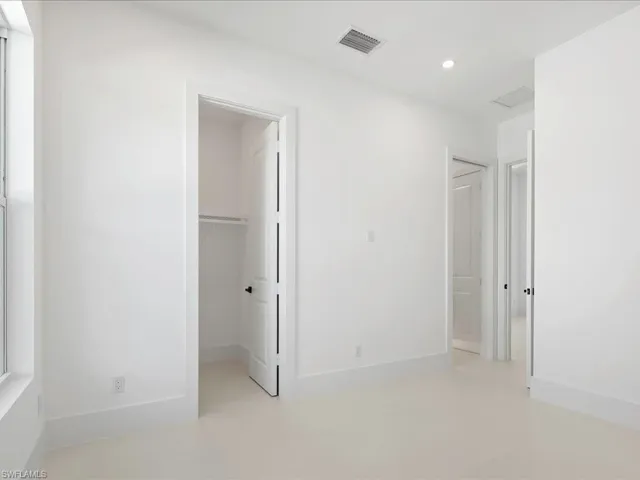 Unfurnished bedroom featuring a spacious closet and recessed lighting