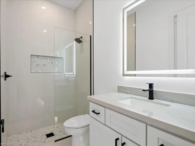 Full bathroom featuring vanity and a shower stall