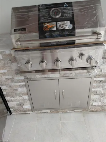 Detailed view of light countertops and gray cabinetry