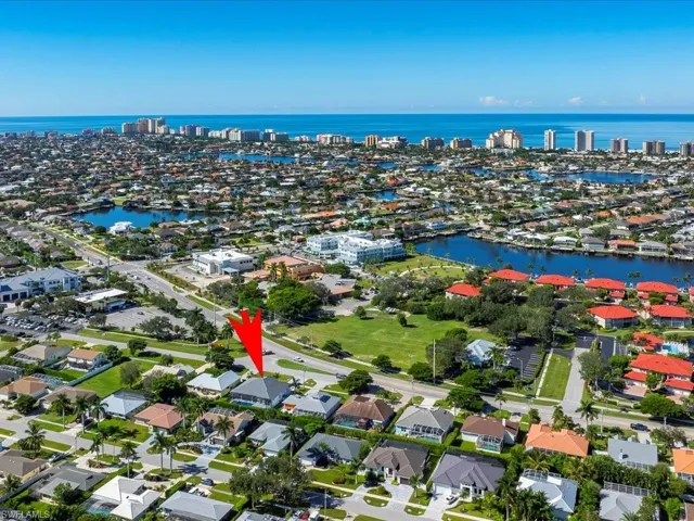 View of property location featuring a nearby body of water and nearby suburban area