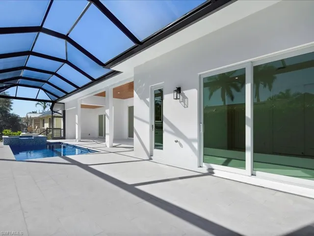 View of swimming pool with a sunroom, a patio, a pool with connected hot tub, and a lanai